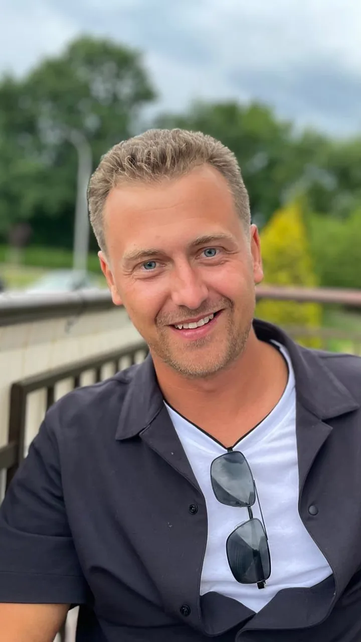 The real terrace photo of Michael Lip that the AI avatar was made from, cropped to portrait