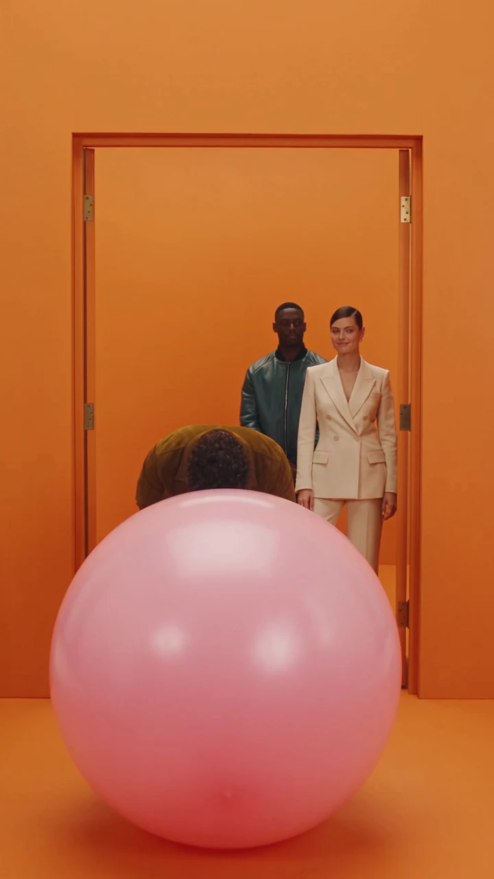 Elliot bows behind the ball, a frame from Think Bigger. AI-generated.