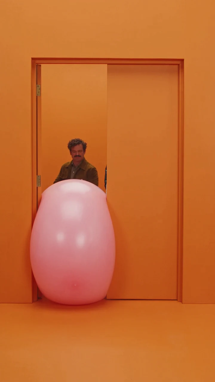Inflatable squeezed into an oval in the narrow gap, a frame from Think Bigger. AI-generated.